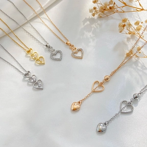 Elegant hollow heart pendant necklaces in gold and silver with sparkling rhinestones