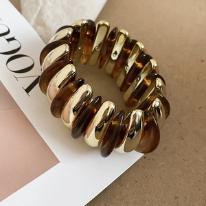 Detail shot of vintage acrylic stretch bracelet with amber resin and gold metal links
