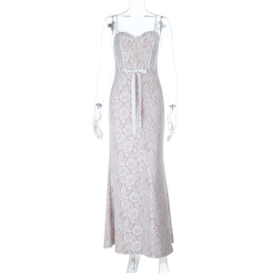 Detailed view of intricate floral lace pattern and delicate waist ribbon bow on the dress