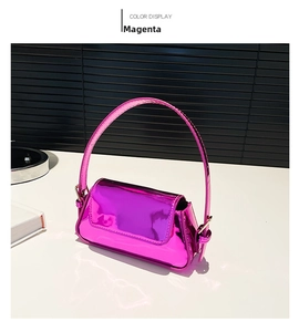 Detail view of mini rose red patent leather shoulder bag with glossy metallic finish
