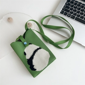 Detailed view of green knitted phone bag featuring a cute panda jacquard and blue button