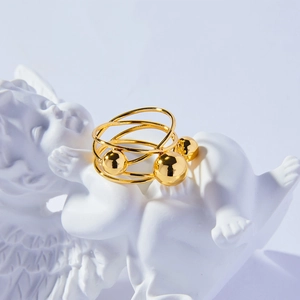 French vintage multilayer gold ring with spherical beads on an angel sculpture