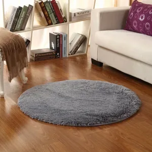 Detail of grey round plush rug with thick pile and anti-slip bottom for bedroom