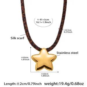 Close-up of leopard print silk scarf necklace with a polished gold star pendant