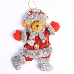 Plush Christmas teddy bear ornament with red fabric, knit hat, and golden hanging string