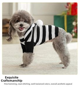 Close-up of black and white striped dog hoodie with pom-pom on hood and ribbed cuffs