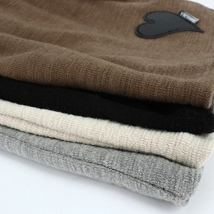 Knit beanies for women in four colors featuring a heart patch and ribbed texture