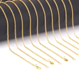Close-up of multiple 2mm golden stainless steel O-link chains with lobster clasps