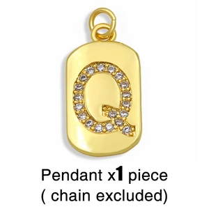 Detail of gold rectangular pendant with pavé set cubic zirconia letter Q design