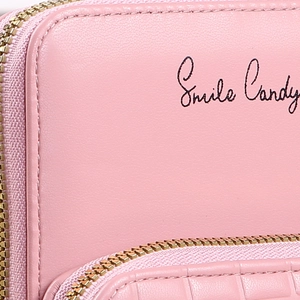 Pink minimalist crossbody phone bag with Smile Candy print and gold zipper detail