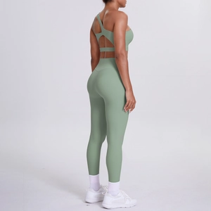 Sage green yoga set featuring a cross-back hollow sports bra and high-waisted leggings