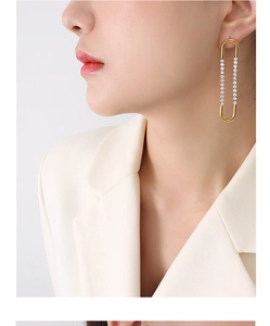 Detailed view of U-shaped 18k gold plated titanium earrings with cubic zirconia inlay