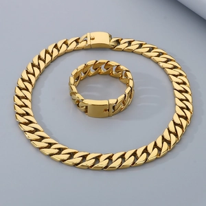 Detailed view of the gold Cuban link chain necklace and bracelet set with metallic luster