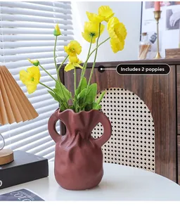 Artistic reddish-brown ceramic vase in tote bag shape with yellow poppy flowers