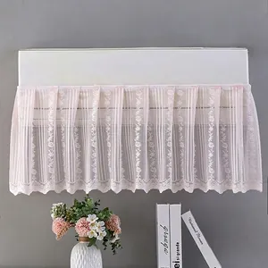 Detailed pink lace embroidery with small floral patterns on a wall AC dust cover