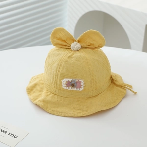 Detail of yellow baby sun hat with bunny ears bow and adjustable drawstring strap