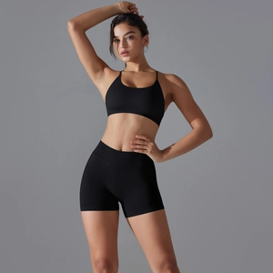 Detail of black seamless ribbed knit yoga set showing back cutout sports bra and high waist shorts