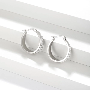 Macro detail of silver stainless steel hoop earrings with double-row cubic zirconia inlay