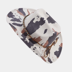 Detail of western cow print felt hat featuring decorative beads and leather strap