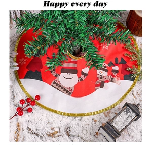 Detail of red Christmas tree skirt with snowman print and elegant gold braided border