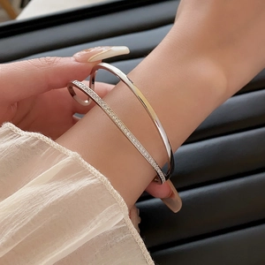 Detail view of a silver double-layered open cuff bracelet with micro-paved cubic zirconia
