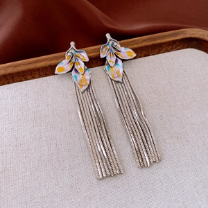 Detail of vintage leaf tassel earrings featuring colorful enamel and long snake chains