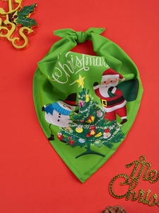 Close-up of green Christmas dog bandana with Santa and snowman print on red background