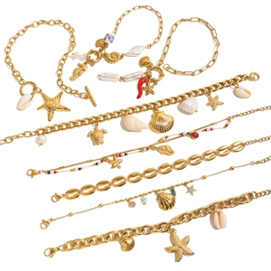 Gold layered ocean charm bracelet set with pearls, starfish, and seahorse pendants