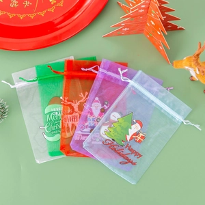 Fan-shaped arrangement of Christmas organza drawstring gift bags with festive patterns