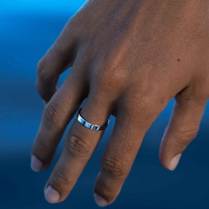 Minimalist silver stainless steel plain ring shown worn on a finger with a matte background