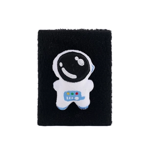 Close-up of black terry cloth wristband featuring a 3D cartoon astronaut embroidery