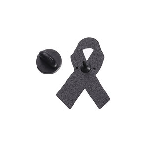 Macro detail of the matte black alloy ribbon brooch with non-slip texture and rubber back