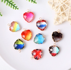 Detailed view of faceted glass heart charms with gold edges and multi-color gradient designs