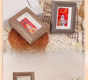 Close-up of wooden motivational photo frames with traditional blessing cards on a desk