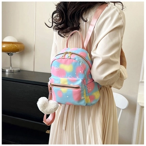 Detail of colorful mini backpack with heart pattern and white heart plush keychain charm