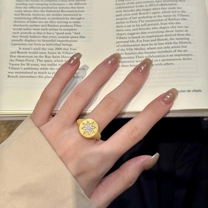 Elegant gold plated starburst signet ring with cubic zirconia stones on matte finish