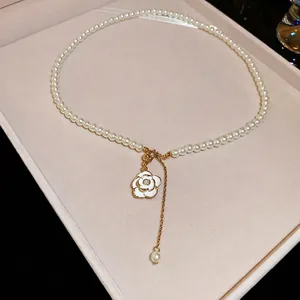 Elegant camellia pearl necklace with gold chain in a premium beige velvet jewelry box