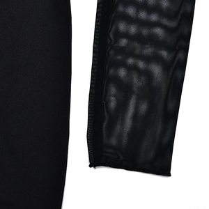Detail of sheer mesh sleeve featuring a white skeleton hand print on a black dress
