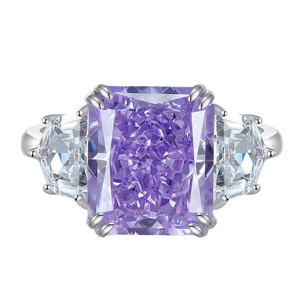 Three-stone silver ring featuring a large radiant cut purple gemstone and side diamonds