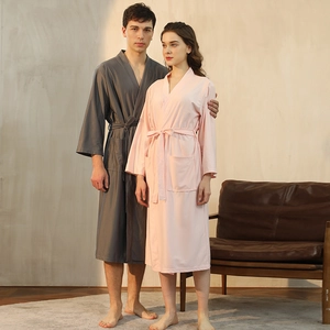 Unisex waffle weave bathrobes in charcoal gray and pale pink with tie waist belts