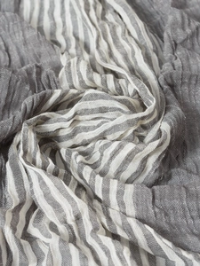 Detail of grey and white striped scarf showing natural linen blend crinkle texture