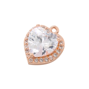 Close-up of 18K gold heart pendant with a large clear zircon surrounded by small crystals