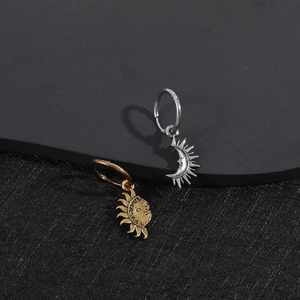 Asymmetric sun and moon dangle earrings in gold and silver finish with retro aesthetic