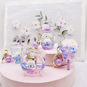 Detail of Cinnamoroll acrylic charms with purple liquid sand and glitter effects