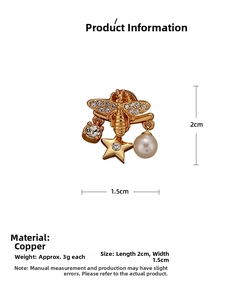 Detailed view of bee and star earrings in copper with rhinestones and white pearl