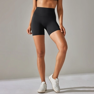 Close-up of high-waisted black yoga shorts showing the elastic fabric and slimming fit