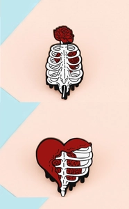 Detail of enamel lapel pins with skeleton ribs and red roses on pink and blue background