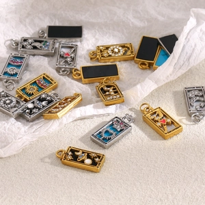 Macro detail of tarot card pendants in gold and silver with colorful inlaid crystals