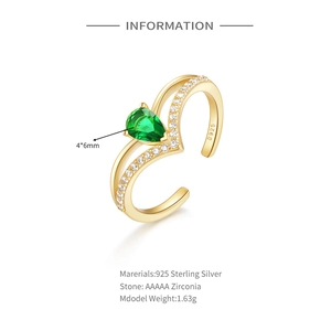 Detail view of gold S925 sterling silver ring with pear-cut green zircon and specs