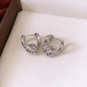 Polished silver twisted knot hoop earrings for women in minimalist metal style